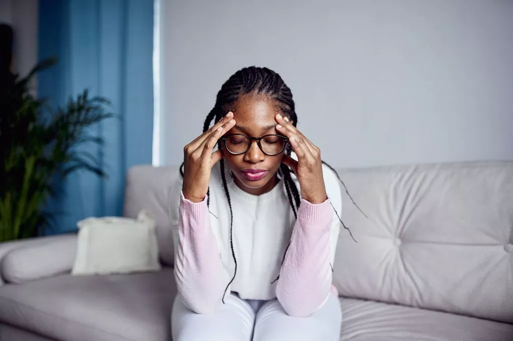 Woman holding her head in her hands